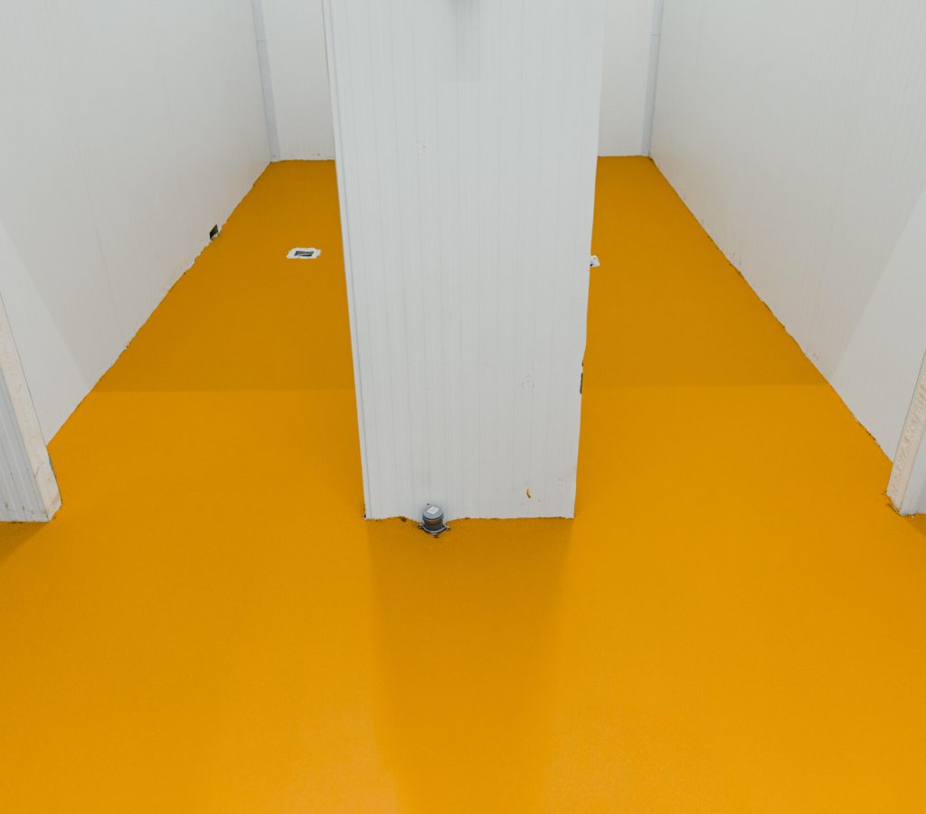 New polished concrete floor covered with a layer of yellow epoxy resin
